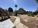 This backyard features a covered patio, desert landscaping, and a block fence, awaiting your personal touch at 4219 E Whitney Ln, Phoenix, AZ 85032
