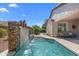 Lush backyard oasis with a custom waterfall pool and serene patio area at 4239 E Azalea Dr, Gilbert, AZ 85298