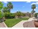 Lush backyard with manicured lawn and mature trees, creating a private oasis at 4239 E Azalea Dr, Gilbert, AZ 85298