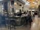 View of the bar area with dark tile and patrons sitting at the bar at 4239 E Azalea Dr, Gilbert, AZ 85298