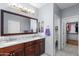 Bathroom featuring double sinks, dark wood cabinets, tile floors, and a walk-in closet at 4239 E Azalea Dr, Gilbert, AZ 85298
