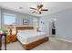 Light-filled primary bedroom with a ceiling fan, ensuite bathroom, and a calm, blue color scheme at 4239 E Azalea Dr, Gilbert, AZ 85298