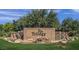Welcoming community entrance sign featuring stone accents, waterfall features, and lush greenery at 4239 E Azalea Dr, Gilbert, AZ 85298