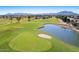 Aerial shot of the golf course with pond, sand trap, and mountain views at 4239 E Azalea Dr, Gilbert, AZ 85298