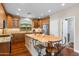 Spacious kitchen features a large island with seating, stainless appliances, granite countertops and wood cabinets at 4239 E Azalea Dr, Gilbert, AZ 85298