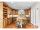 Well-equipped kitchen featuring wood cabinets, stainless steel appliances, and a center island with seating at 4239 E Azalea Dr, Gilbert, AZ 85298