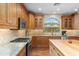 Stylish kitchen with granite countertops, stainless steel appliances, custom cabinets, and island with seating at 4239 E Azalea Dr, Gilbert, AZ 85298