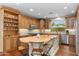 Spacious kitchen featuring a center island with seating, custom cabinetry and stainless steel appliances at 4239 E Azalea Dr, Gilbert, AZ 85298