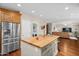 Open kitchen layout with a large island, stainless steel refrigerator, and a view into the living area at 4239 E Azalea Dr, Gilbert, AZ 85298