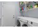 Functional laundry room with modern washer and dryer units and ample shelving at 4239 E Azalea Dr, Gilbert, AZ 85298