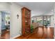 Open living room with hardwood floors, built in shelving, and backyard views at 4239 E Azalea Dr, Gilbert, AZ 85298