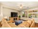 Inviting living room with large windows, hardwood floors, a comfortable sectional, and a ceiling fan at 4239 E Azalea Dr, Gilbert, AZ 85298