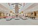 Spacious lobby area with a stone fireplace, soaring ceilings, comfortable seating, and a pool table at 4239 E Azalea Dr, Gilbert, AZ 85298