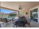 Inviting covered patio with a ceiling fan and stylish outdoor furniture near the pool at 4239 E Azalea Dr, Gilbert, AZ 85298