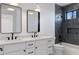 Modern bathroom features a double sink vanity and a tiled shower with glass door at 4301 E Sells Dr, Phoenix, AZ 85018