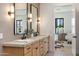 Modern bathroom featuring dual sinks, quartz countertops, and contemporary lighting fixtures at 4301 E Sells Dr, Phoenix, AZ 85018
