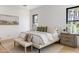 Bright bedroom featuring hardwood floors, neutral colors, and windows with an outdoor view at 4301 E Sells Dr, Phoenix, AZ 85018
