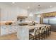 Bright kitchen featuring a large kitchen island with seating, stainless steel appliances, and white cabinets at 4301 E Sells Dr, Phoenix, AZ 85018