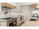 Gourmet kitchen featuring a stainless steel stove, granite countertops, and modern appliances at 4301 E Sells Dr, Phoenix, AZ 85018