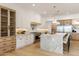 Bright kitchen featuring a large kitchen island with seating, stainless steel appliances, and glass cabinets at 4301 E Sells Dr, Phoenix, AZ 85018