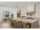 Bright kitchen featuring a large kitchen island with seating, stainless steel appliances, and hardwood floors at 4301 E Sells Dr, Phoenix, AZ 85018