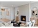 Bright living room featuring a fireplace, hardwood floors, and modern decor at 4301 E Sells Dr, Phoenix, AZ 85018