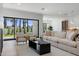 Bright living room featuring a large sofa, hardwood floors, and a sliding door with backyard views at 4301 E Sells Dr, Phoenix, AZ 85018
