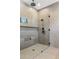 Contemporary tiled shower with frameless glass enclosure, rain shower head, and niche storage at 4301 E Sells Dr, Phoenix, AZ 85018