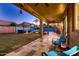 Expansive backyard with a covered patio, a gazebo with lounge furniture, and manicured landscaping at 4437 E Dartmouth St, Mesa, AZ 85205