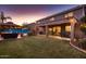 Spacious backyard with a covered patio, a gazebo, a well-manicured lawn, and elegant patio furniture at 4437 E Dartmouth St, Mesa, AZ 85205