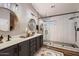 A renovated bathroom features double sinks, a large shower, and modern lighting fixtures at 4437 E Dartmouth St, Mesa, AZ 85205