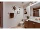Stylish bathroom with a framed mirror, dark wood cabinets, and neutral wall color at 4437 E Dartmouth St, Mesa, AZ 85205