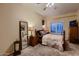 Comfortable bedroom with neutral colors, matching wood furniture, and natural lighting at 4437 E Dartmouth St, Mesa, AZ 85205