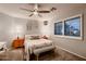 This bedroom offers neutral colors, natural light, and earth-toned carpet at 4437 E Dartmouth St, Mesa, AZ 85205