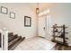 Inviting entryway featuring tiled floors, staircase, modern light fixture, and decorative elements for a warm welcome at 4437 E Dartmouth St, Mesa, AZ 85205