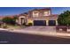 Charming two-story home with a well-manicured lawn and a three-car garage at 4437 E Dartmouth St, Mesa, AZ 85205