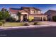Charming two-story home with a well-manicured lawn and three-car garage at 4437 E Dartmouth St, Mesa, AZ 85205