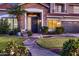Inviting home entrance with stone accents, manicured lawn, and welcoming wreath at 4437 E Dartmouth St, Mesa, AZ 85205