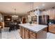 Spacious kitchen featuring stainless steel appliances, a tile backsplash, and an island at 4437 E Dartmouth St, Mesa, AZ 85205