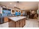 Spacious kitchen with marble countertops, an island, and a view of the living room at 4437 E Dartmouth St, Mesa, AZ 85205