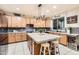 Spacious kitchen with a center island, marble countertops, stainless steel appliances, and stylish lighting at 4437 E Dartmouth St, Mesa, AZ 85205