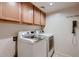 Well-lit laundry room featuring a washer and dryer, with plenty of cabinet space for storage at 4437 E Dartmouth St, Mesa, AZ 85205
