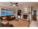 Cozy living room features a ceiling fan, fireplace with mantle, and comfortable seating area at 4437 E Dartmouth St, Mesa, AZ 85205
