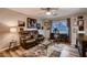 Inviting living room with a comfortable leather recliner, ceiling fan, and a desk area by the window at 4437 E Dartmouth St, Mesa, AZ 85205
