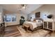Spacious bedroom offers hardwood floors, natural lighting, and a decorative area rug at 4437 E Dartmouth St, Mesa, AZ 85205