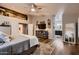 Bright main bedroom with hardwood floors, TV, with a view of the bathroom at 4437 E Dartmouth St, Mesa, AZ 85205