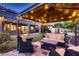Outdoor living area with a covered gazebo, comfortable seating, and a well-maintained lawn at 4437 E Dartmouth St, Mesa, AZ 85205