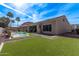 Expansive backyard with lush green turf, sparkling pool, covered patio, and ample space for outdoor activities at 4667 E Reins Rd, Gilbert, AZ 85297