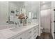 Modern bathroom with a double sink vanity, quartz countertop, and decorative flower arrangement at 4667 E Reins Rd, Gilbert, AZ 85297
