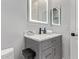 Modern bathroom featuring a marble countertop, decorative candle, and vanity mirror at 4667 E Reins Rd, Gilbert, AZ 85297